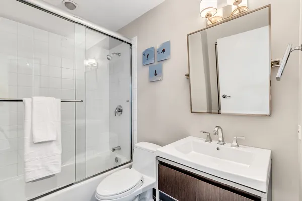 a bathroom with a sink toilet and shower
