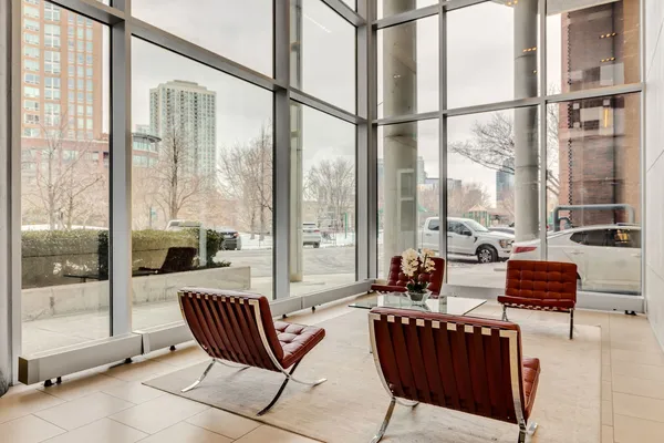 a living room with furniture and a floor to ceiling window