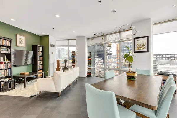 a living room with furniture wooden floor and a flat screen tv