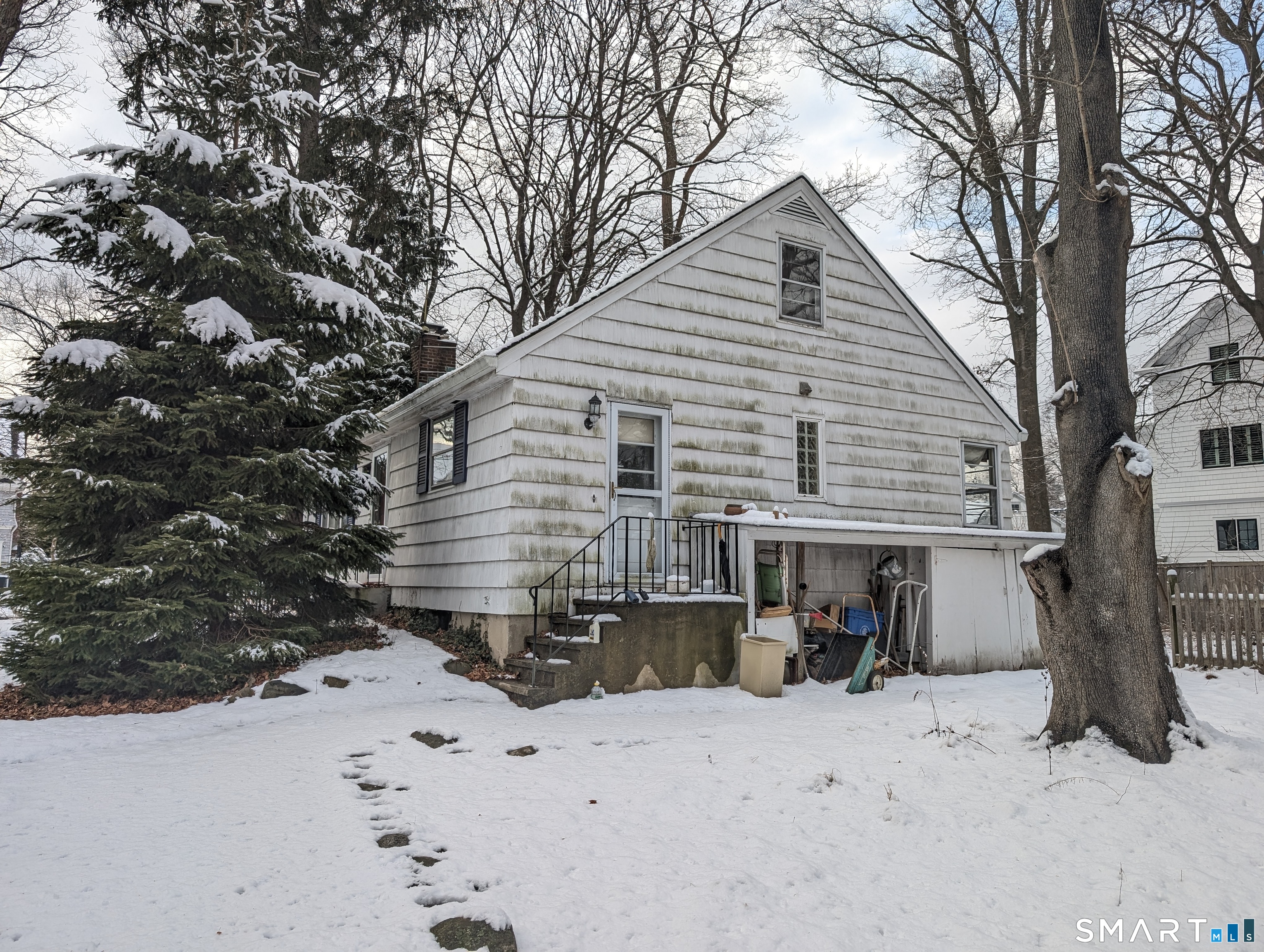 1 Dexter Road Westport, CT 06880 - Photo 3 of 29 a front view of a house with a yard covered in snow