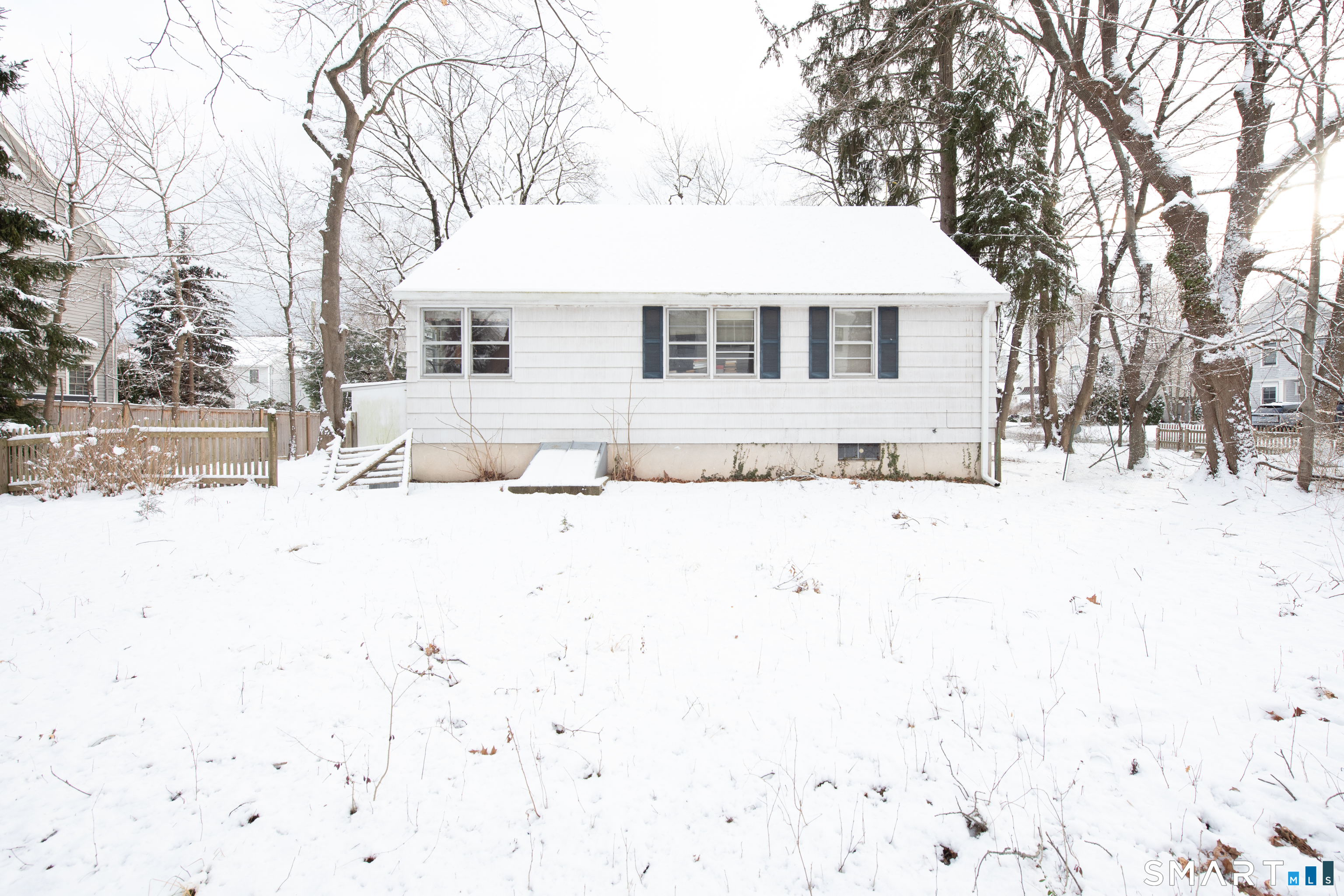 1 Dexter Road Westport, CT 06880 - Photo 4 of 29 a front view of a house with a yard covered in snow