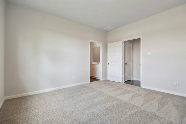 a view of an empty room and closet area