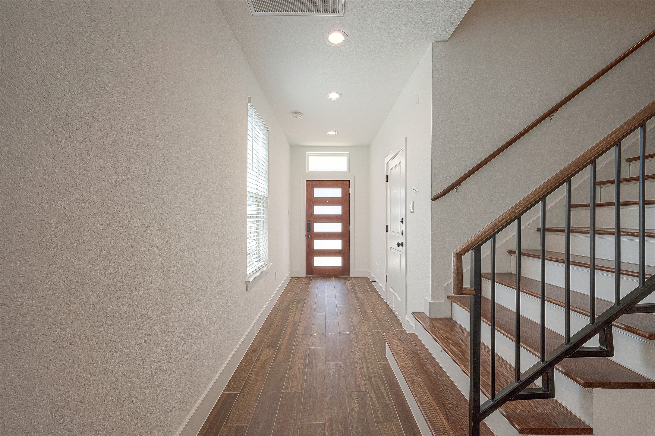 13419 Scott Street Houston, TX 77047 - Photo 3 of 23 a view of a hallway with wooden floor and staircase