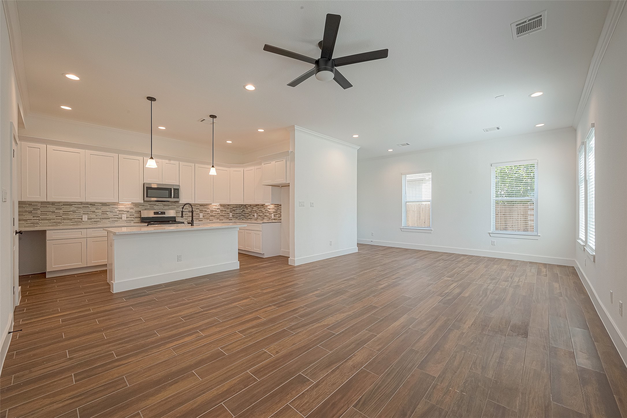 13419 Scott Street Houston, TX 77047 - Photo 4 of 23 a view of kitchen with granite countertop window and white cabinets