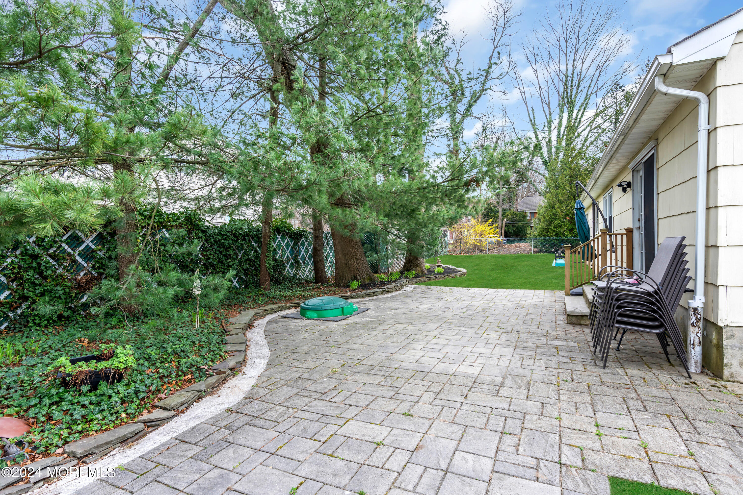 70 Portland Road Atlantic Highlands, NJ 07716 - Photo 27 of 32 a view of backyard with table and chairs and potted plants