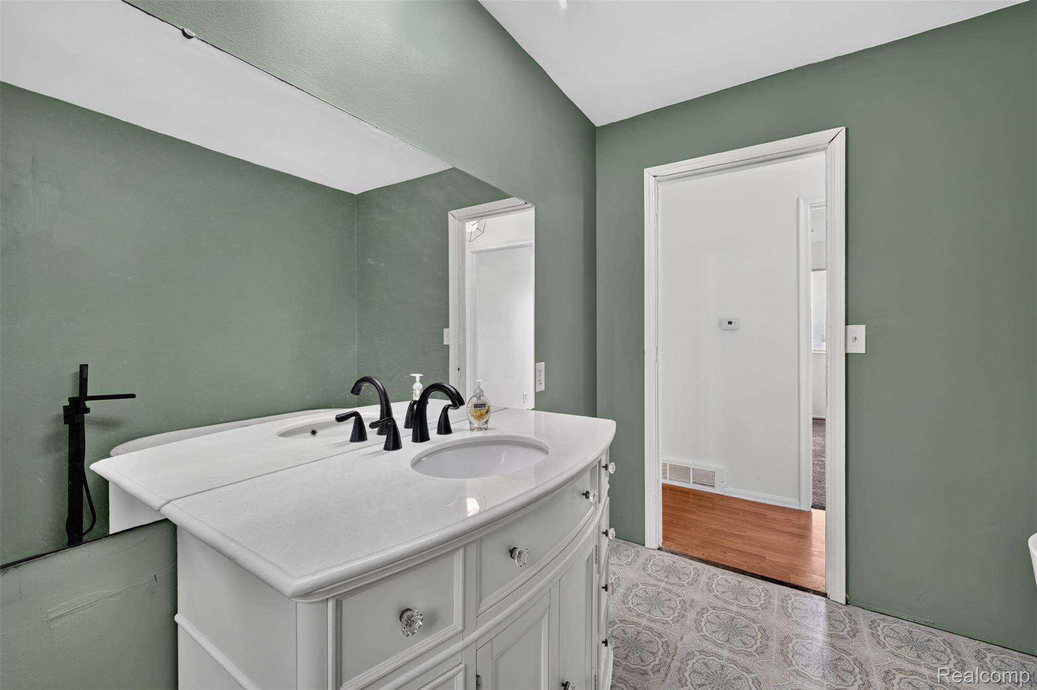 5457 Reid Road Swartz Creek, MI 48473 - Photo 25 of 51 Bathroom vanity with dual undermount sinks, matte black faucets, and a white countertop