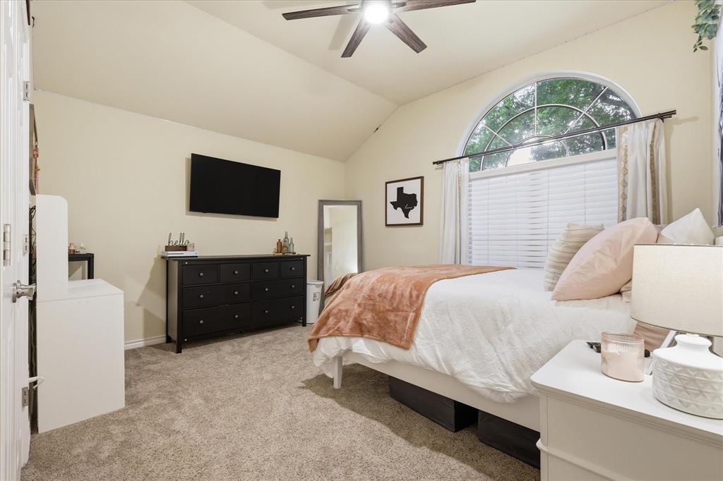 202 Colonial Heights Sanger, TX 76266 - Photo 20 of 27 a bedroom with a bed and a flat screen tv