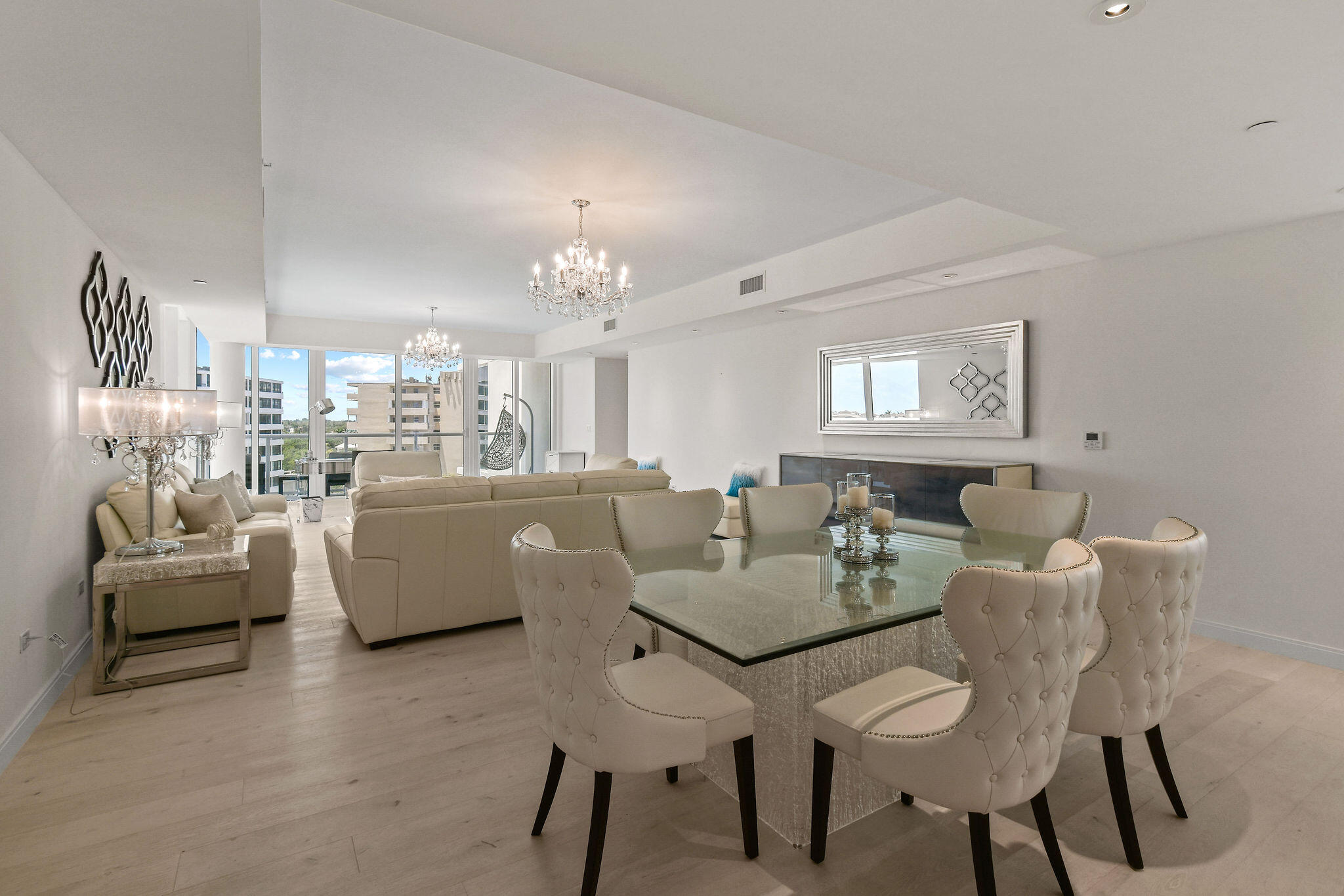 3550 South Ocean Boulevard, Unit 5E South Palm Beach, FL 33480 - Photo 11 of 52 a view of a dining room with furniture and chandelier