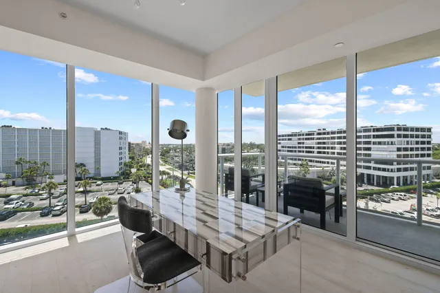 a kitchen with stainless steel appliances granite countertop a stove top oven a sink a dining table and chairs