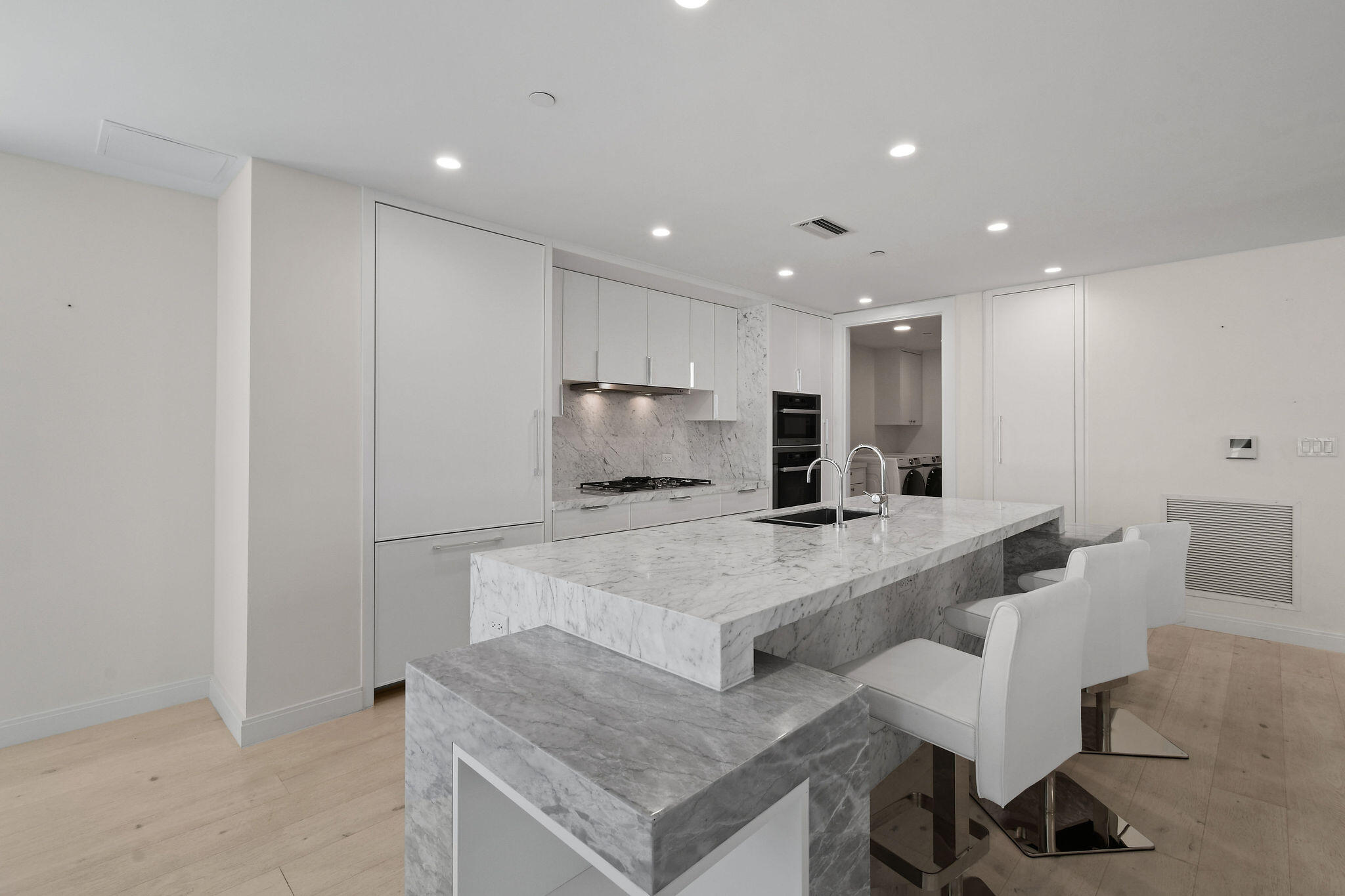 3550 South Ocean Boulevard, Unit 5E South Palm Beach, FL 33480 - Photo 17 of 52 a large white kitchen with a large window