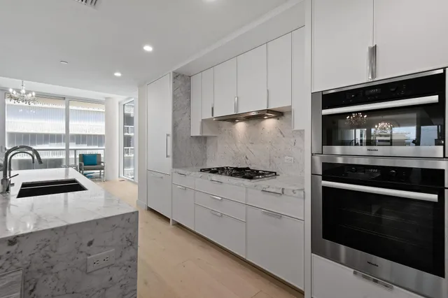 a stove top oven sitting inside of a kitchen