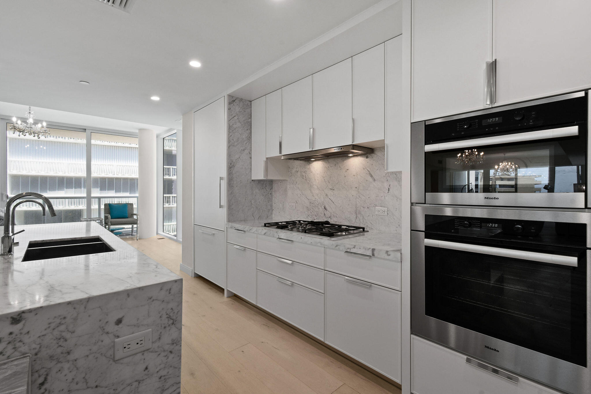 3550 South Ocean Boulevard, Unit 5E South Palm Beach, FL 33480 - Photo 18 of 52 a kitchen with stainless steel appliances granite countertop a stove a sink and a microwave