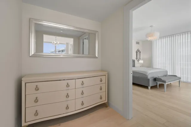 a bedroom with a bed and a chandelier