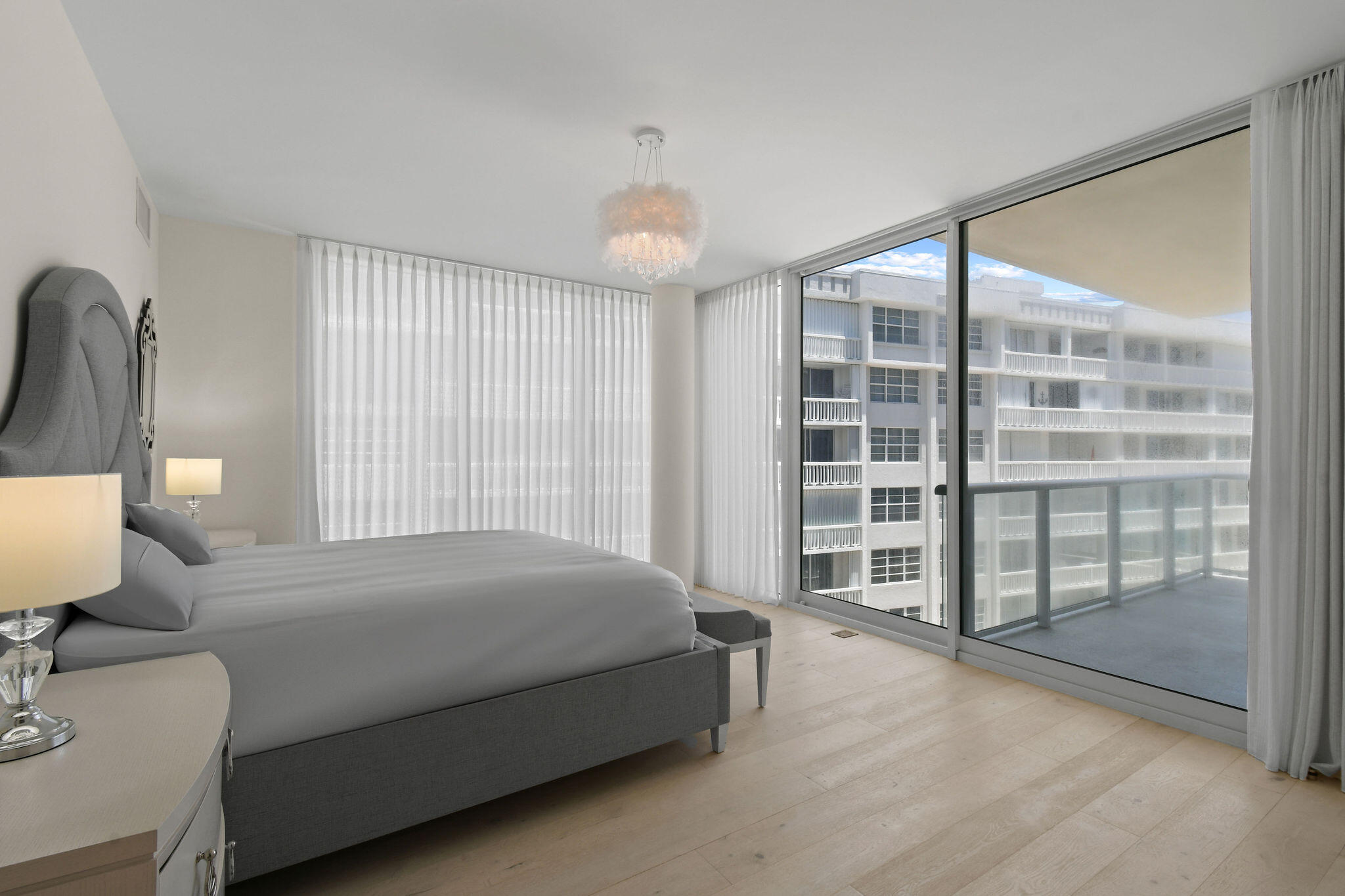 3550 South Ocean Boulevard, Unit 5E South Palm Beach, FL 33480 - Photo 26 of 52 a bedroom with a bed and a large window