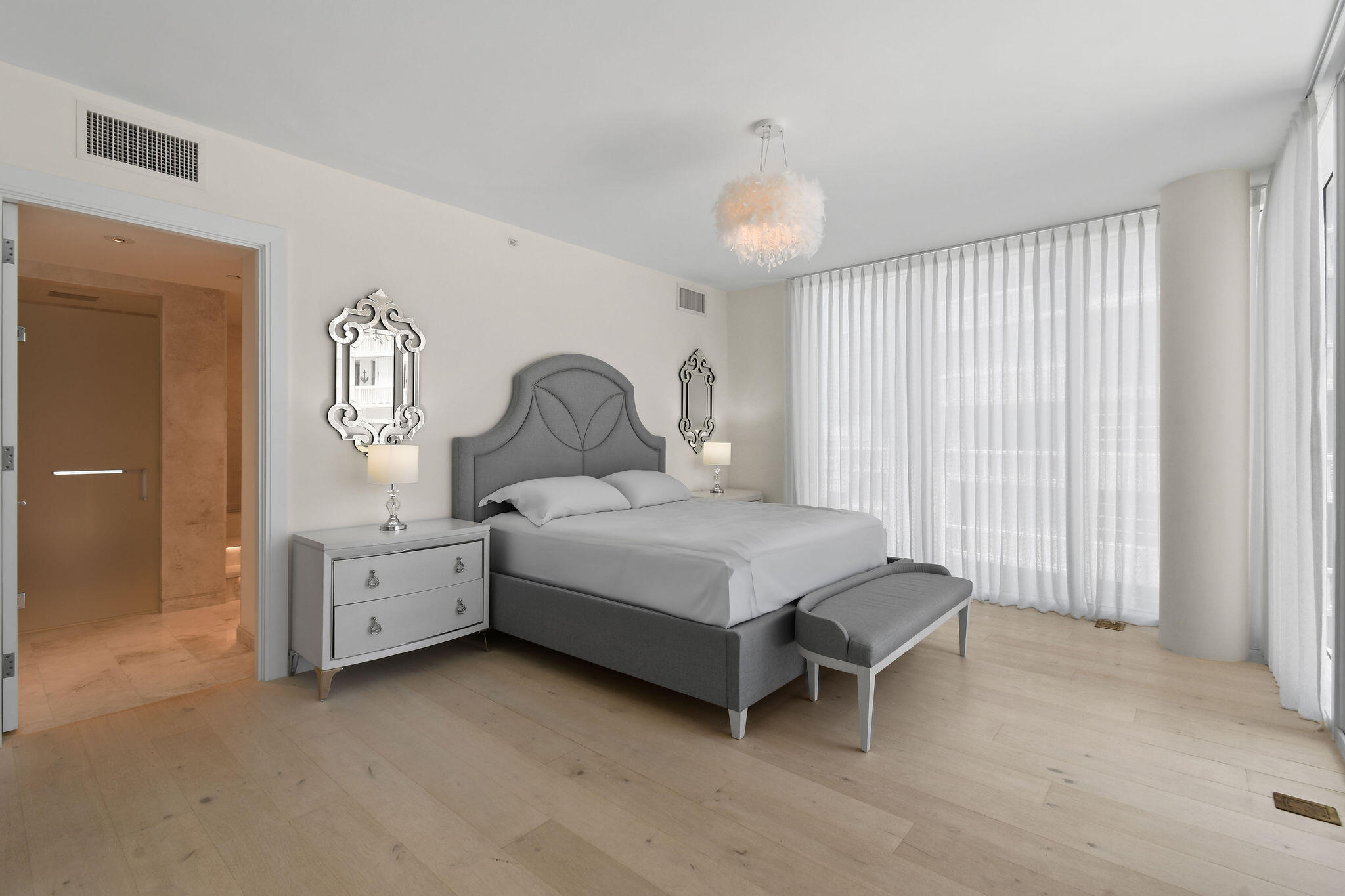 3550 South Ocean Boulevard, Unit 5E South Palm Beach, FL 33480 - Photo 28 of 52 a bedroom with a bed and a chandelier