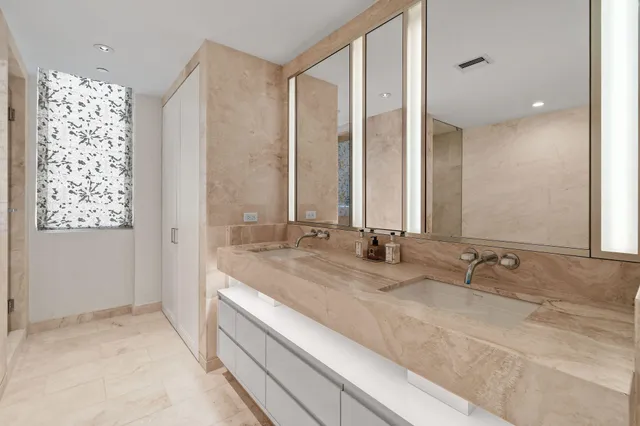 a bedroom with a bed and a mirror