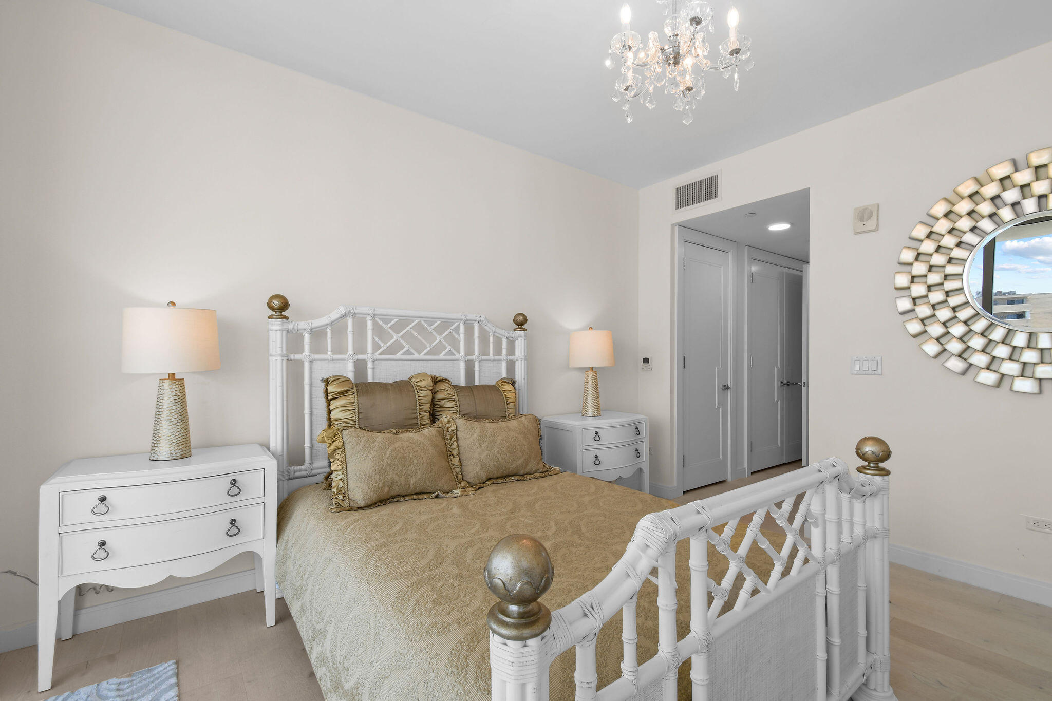 3550 South Ocean Boulevard, Unit 5E South Palm Beach, FL 33480 - Photo 35 of 52 a bedroom with a bed and a chandelier