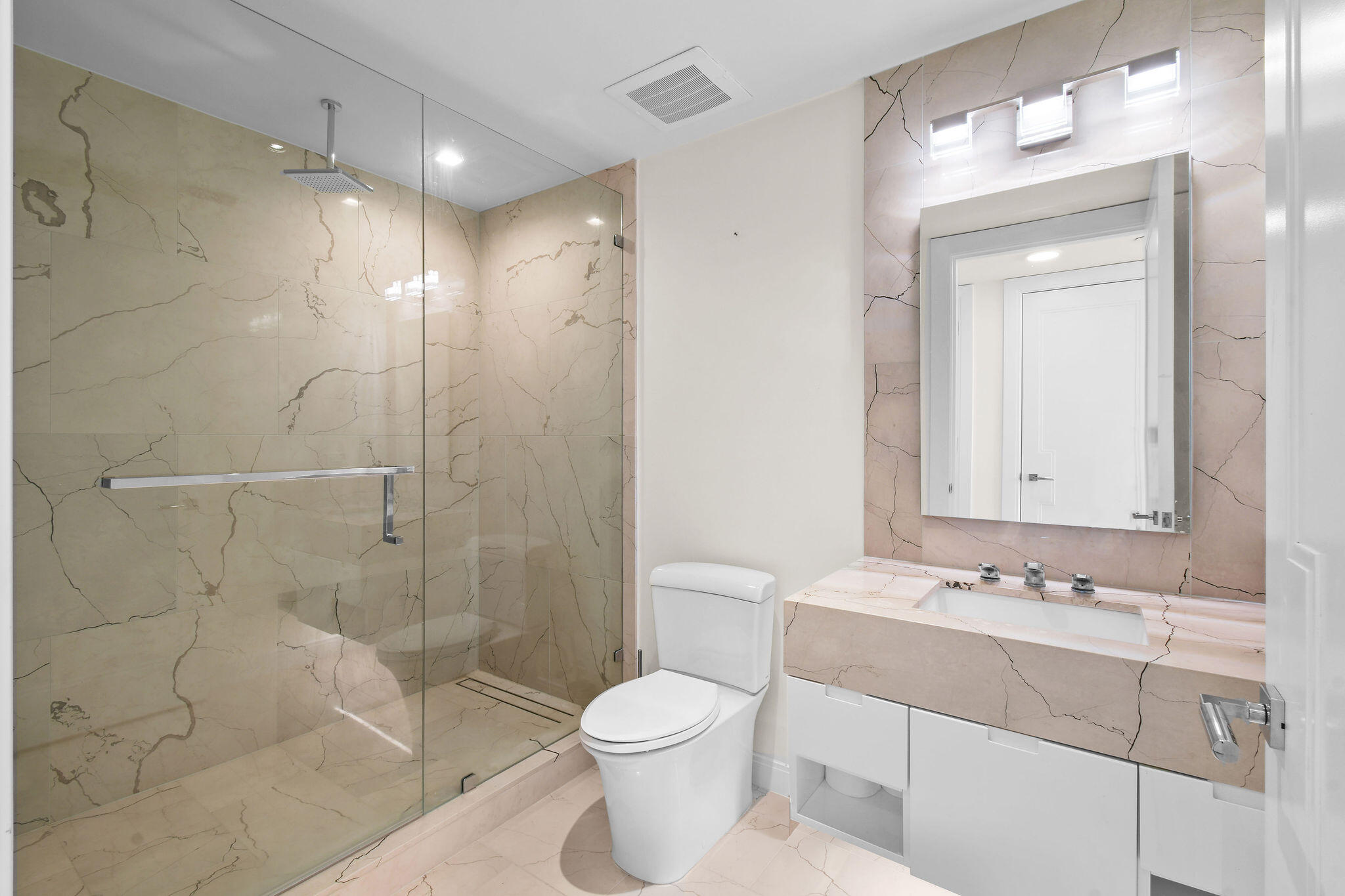 3550 South Ocean Boulevard, Unit 5E South Palm Beach, FL 33480 - Photo 36 of 52 a bathroom with a sink toilet a mirror and shower