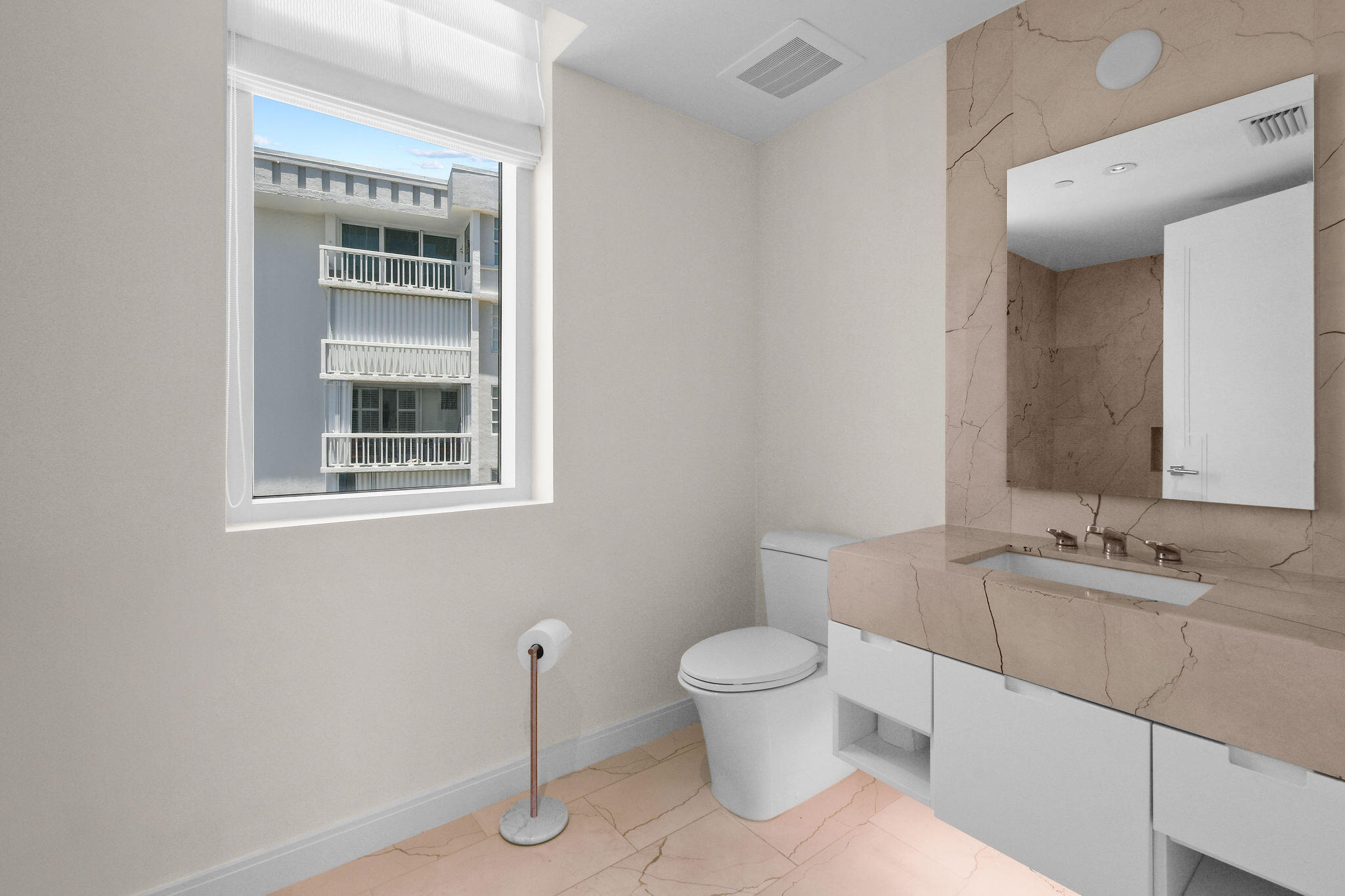 3550 South Ocean Boulevard, Unit 5E South Palm Beach, FL 33480 - Photo 40 of 52 a bathroom with a toilet sink and mirror