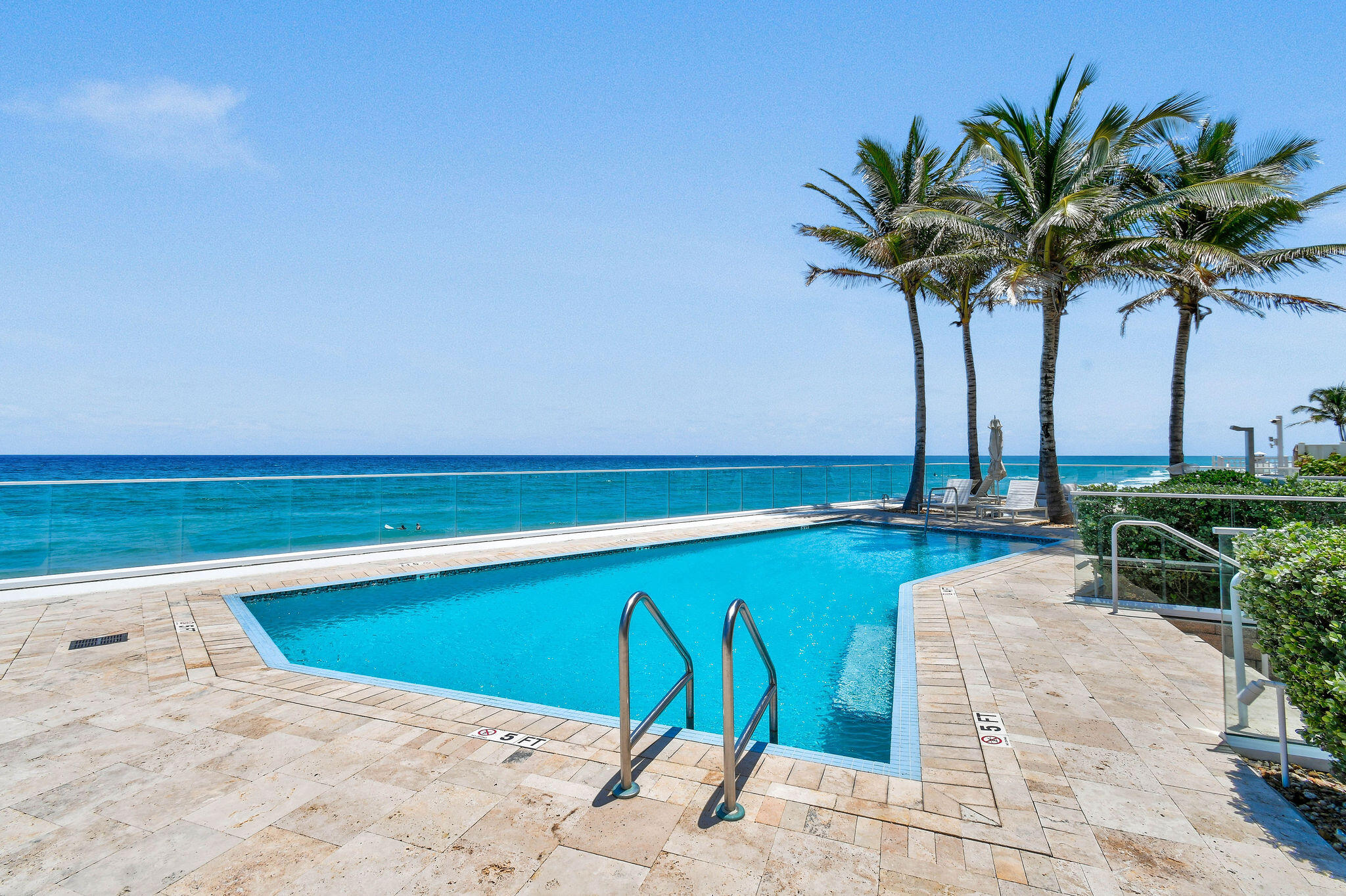 3550 South Ocean Boulevard, Unit 5E South Palm Beach, FL 33480 - Photo 48 of 52 a view of a swimming pool with a yard and a bench