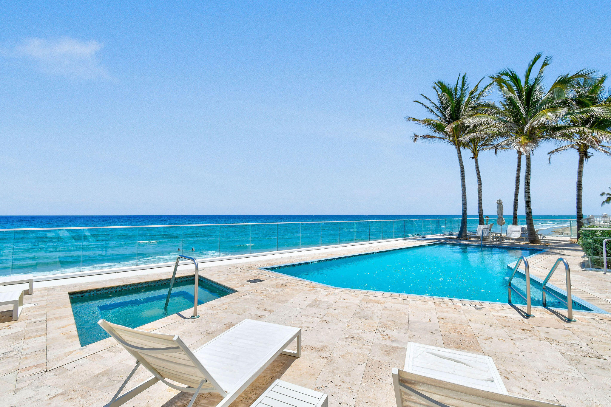 3550 South Ocean Boulevard, Unit 5E South Palm Beach, FL 33480 - Photo 49 of 52 a view of a swimming pool with a lounge chair