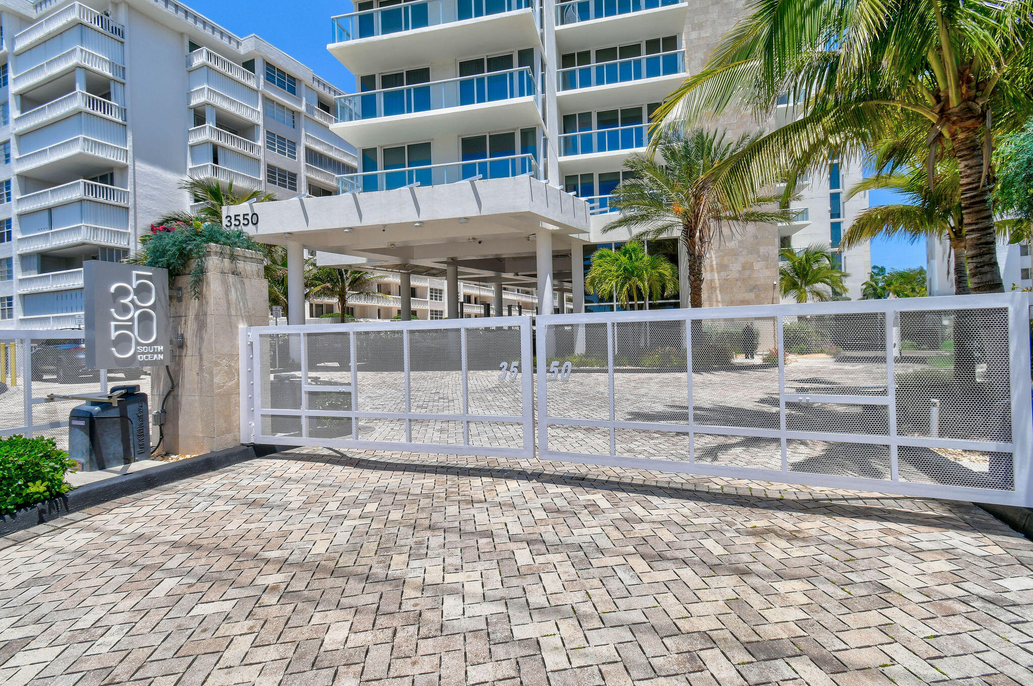 3550 South Ocean Boulevard, Unit 5E South Palm Beach, FL 33480 - Photo 8 of 52 a view of a house with a large window and wooden fence