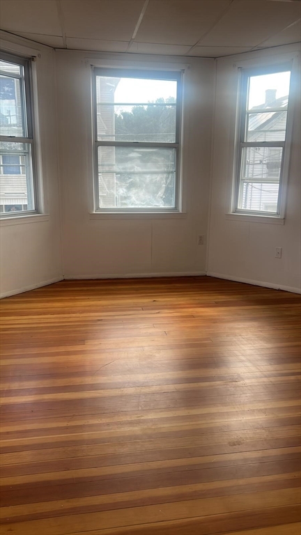 24-28 Hall Street Fall River, MA 02724 - Photo 7 of 13 an empty room with wooden floor and windows