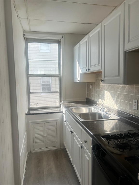 24-28 Hall Street Fall River, MA 02724 - Photo 8 of 13 a kitchen with a sink stove and cabinets