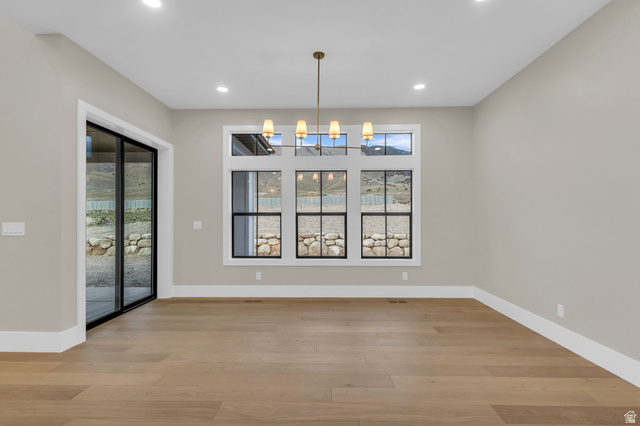 2828 Jojo Road Eagle Mountain, UT 84005 - Photo 17 of 63 Spacious interior room featuring light wood-finish flooring, recessed lighting, and a modern chandelier