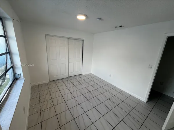 a view of an empty room and wooden floor