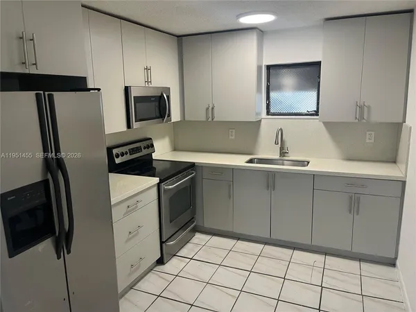 a kitchen with cabinets and stainless steel appliances