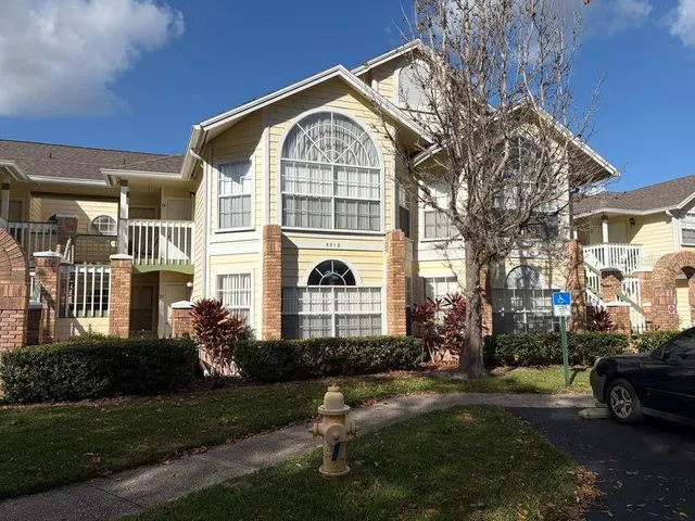 a front view of a house with a garden and yard