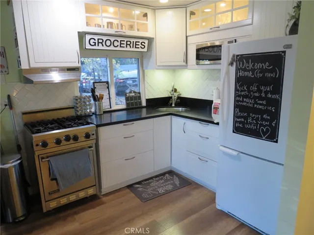 a dining room with furniture a window and wooden floor