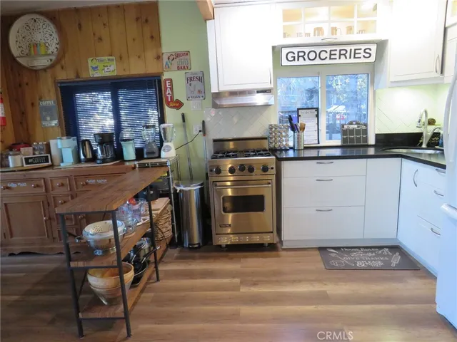 a living room with furniture a clock and wall paintings
