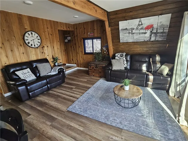 a dining hall with stainless steel appliances kitchen island granite countertop a dining table chairs and a oven