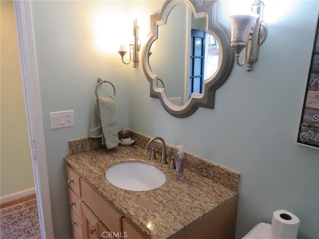 a kitchen with granite countertop a stove a sink and a cabinets
