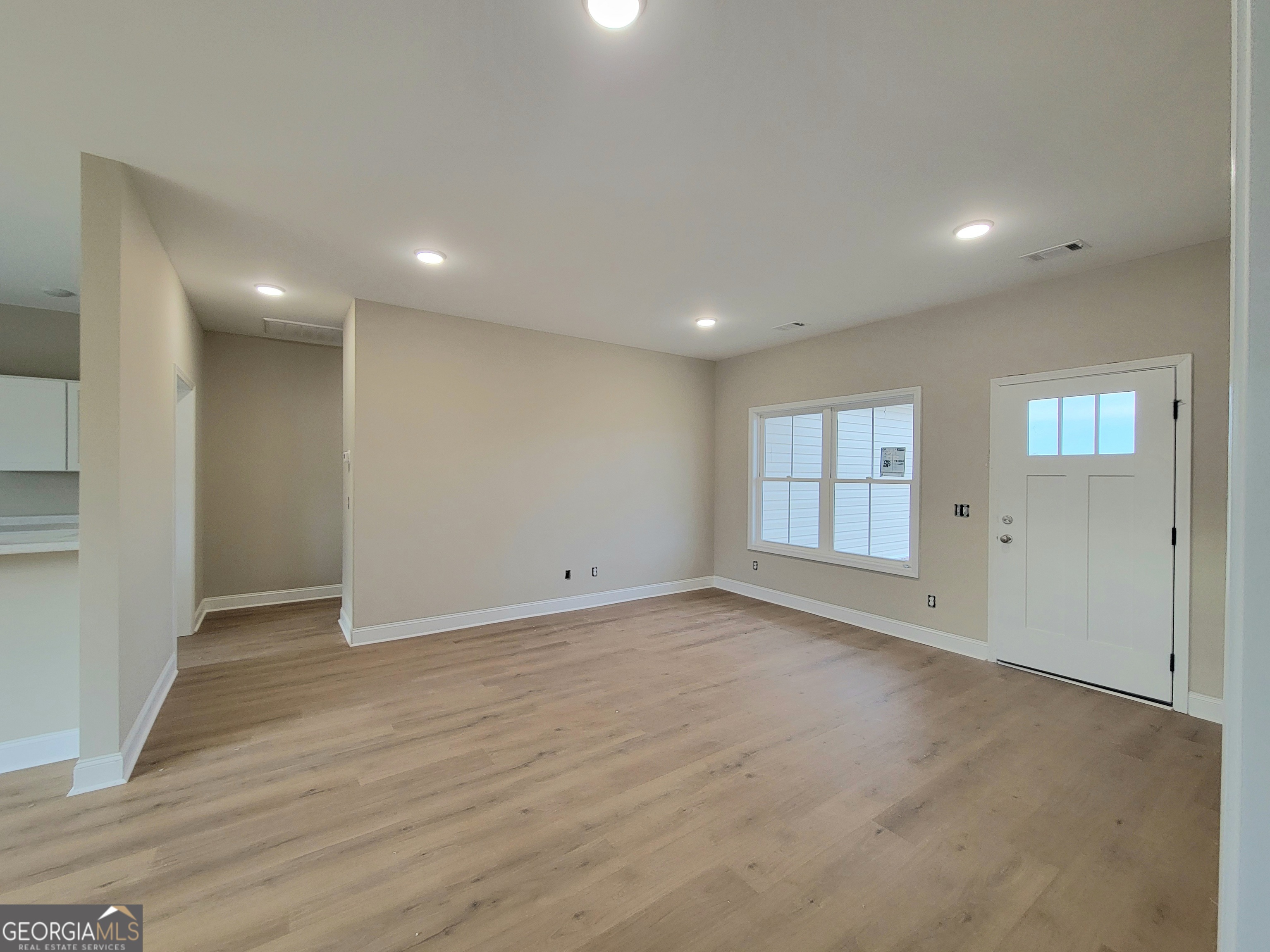 350 Rucker Lane Statesboro, GA 30458 - Photo 4 of 19 an empty room with wooden floor and windows