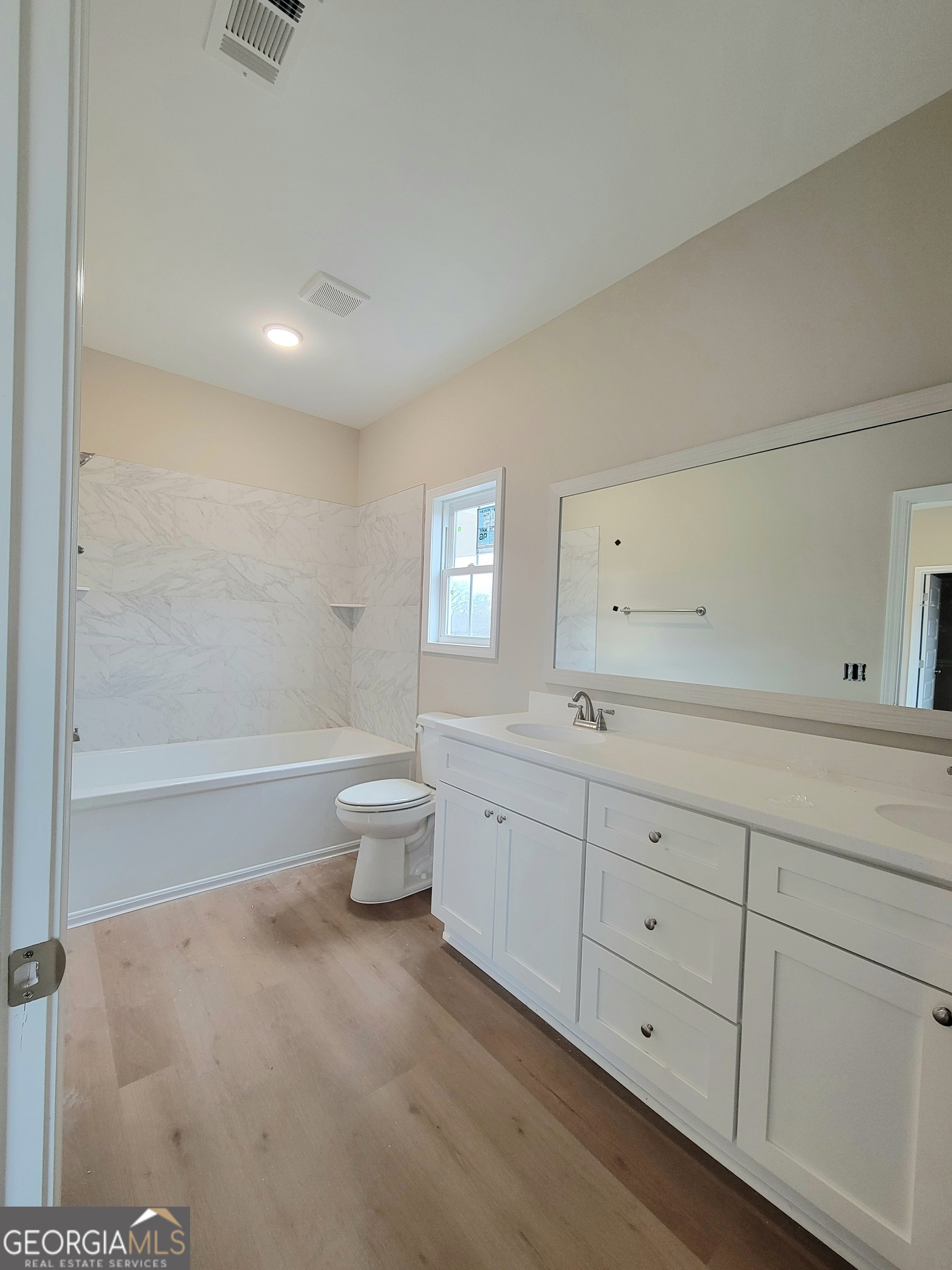 350 Rucker Lane Statesboro, GA 30458 - Photo 9 of 19 a spacious bathroom with a double vanity sink a toilet and a tub