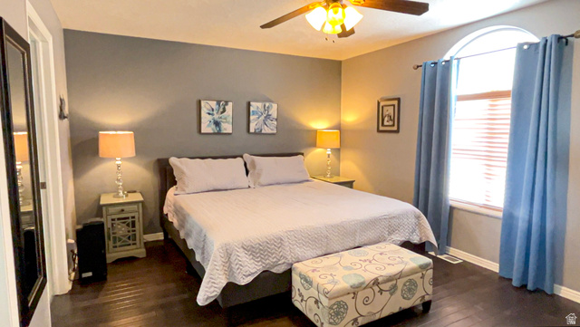 1797 Sunset Road Enoch, UT 84721 - Photo 20 of 80 Spacious bedroom featuring dark wood-finish flooring and a contemporary ceiling fan with integrated lighting