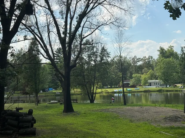 a backyard of a house with lots of green space and fountain