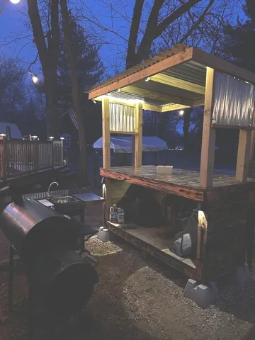 a view of a room with table chairs and wooden floor