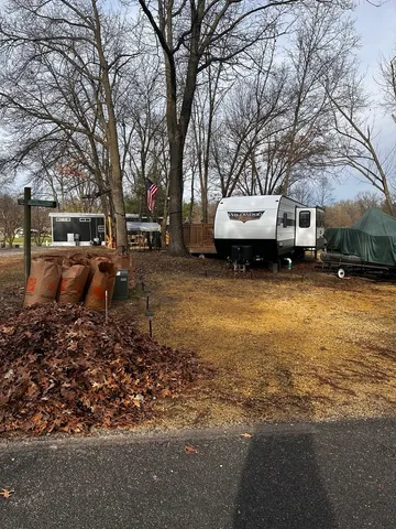 a backyard of a house with barbeque oven and outdoor seating