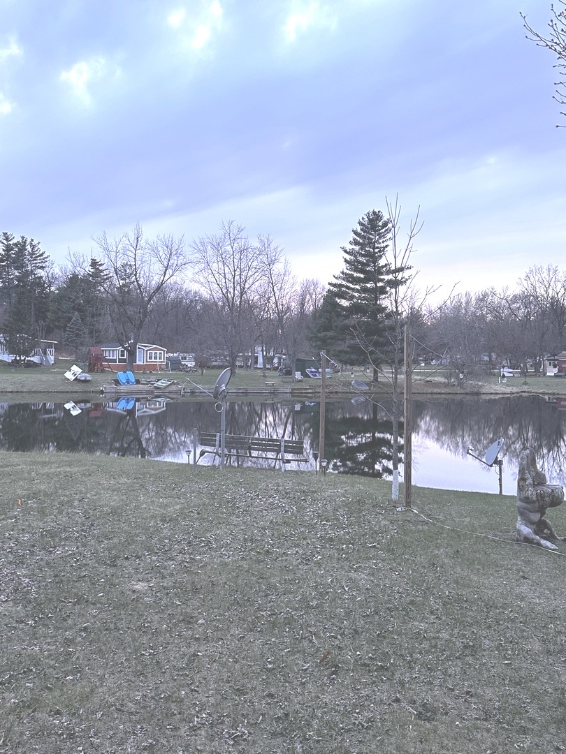 5-464 Woodhaven Lakes Sublette, IL 61367 - Photo 7 of 48 a view of a lake with a building in the background