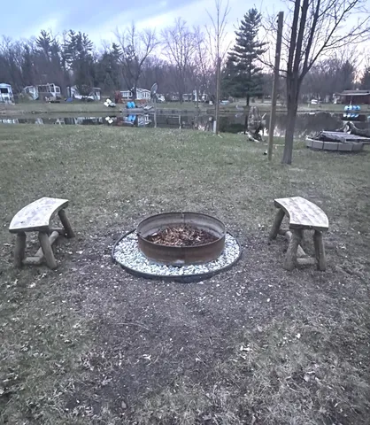 a view of a backyard with lawn chairs