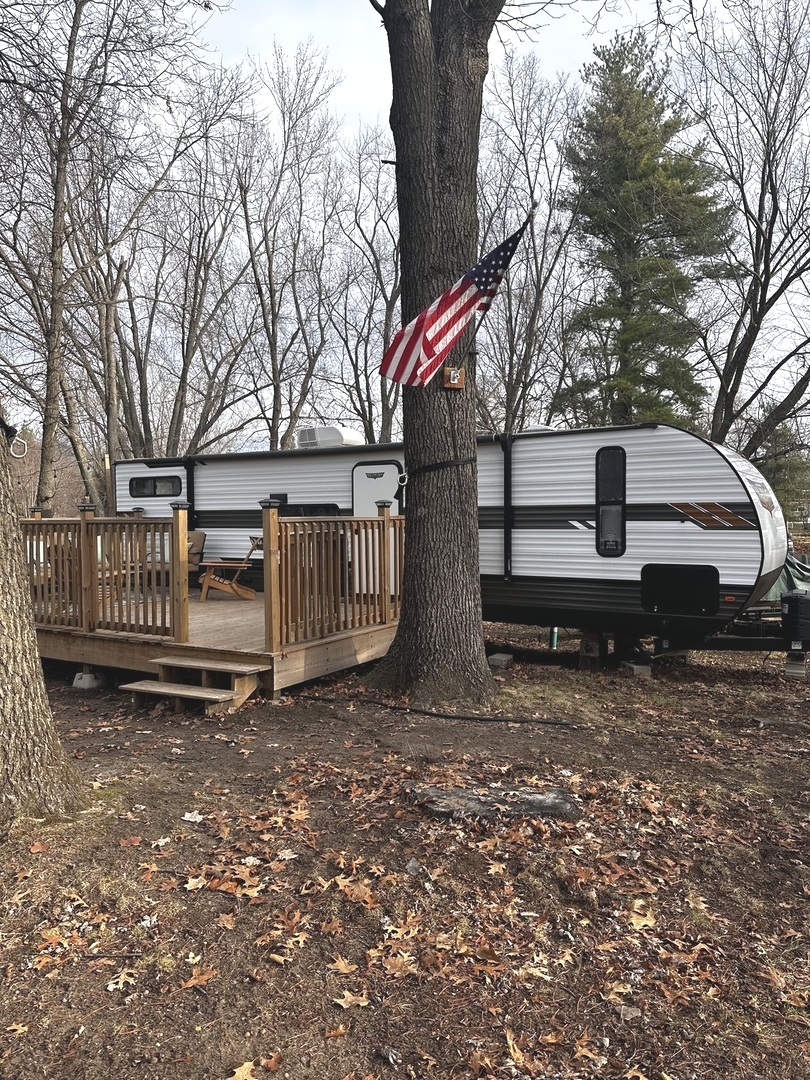 5-464 Woodhaven Lakes Sublette, IL 61367 - Photo 10 of 48 a view of a bench in the backyard with large trees