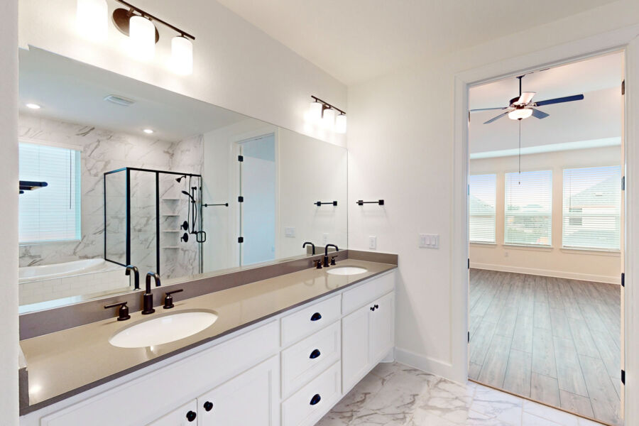 3825 Waxahachie Road Leander, TX 78641 - Photo 18 of 40 a bathroom with a double vanity sink and a mirror