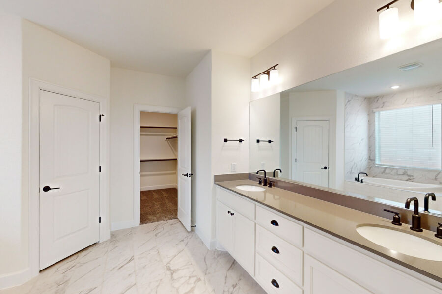 3825 Waxahachie Road Leander, TX 78641 - Photo 24 of 40 a spacious bathroom with a granite countertop sink and a mirror