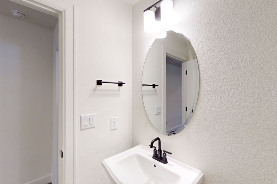 3825 Waxahachie Road Leander, TX 78641 - Photo 29 of 40 a bathroom with a sink and a mirror