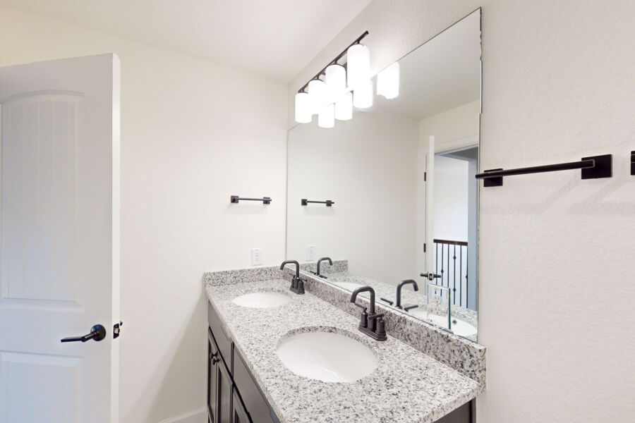 3825 Waxahachie Road Leander, TX 78641 - Photo 32 of 40 a bathroom with a granite countertop sink a mirror and shower
