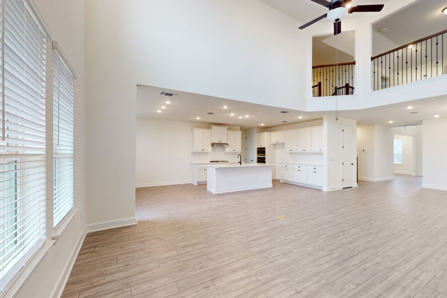 3825 Waxahachie Road Leander, TX 78641 - Photo 4 of 40 a view of a kitchen with kitchen island stainless steel appliances wooden floor and a window